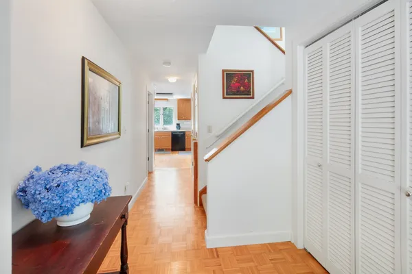 a view of hallway with furniture and a window