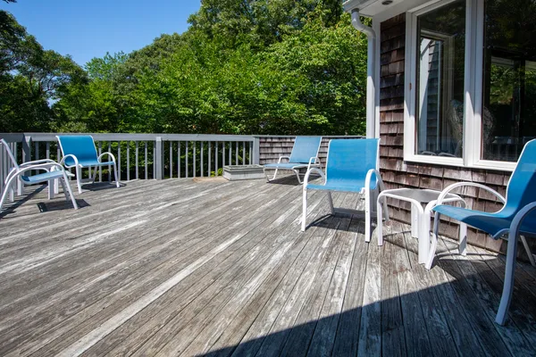 a view of a chairs and table on the wooden deck