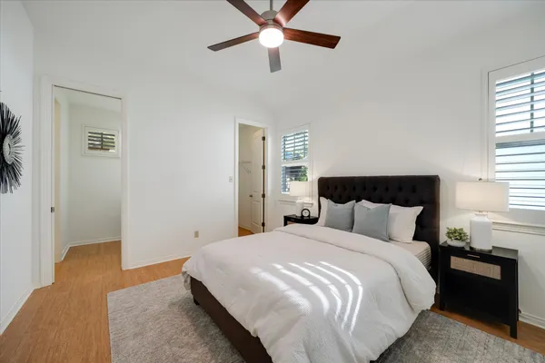 a bedroom with bed and wooden floor