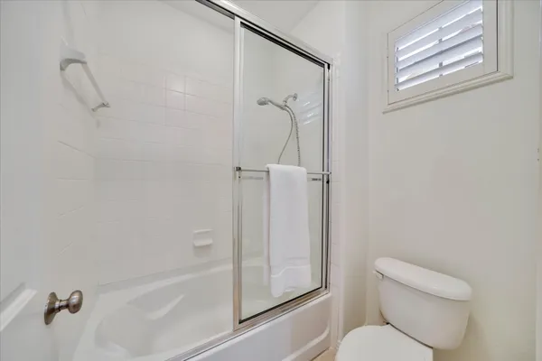 a bathroom with a shower a toilet and a shower