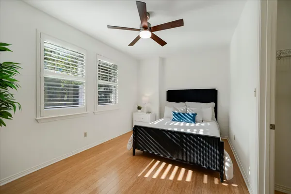 a bedroom with a bed and wooden floor