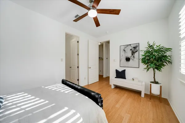 a bedroom with a bed and a chandelier