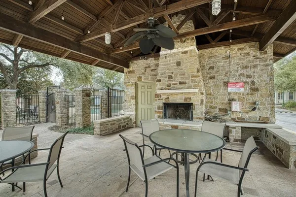 a outdoor dining space with furniture and a fireplace