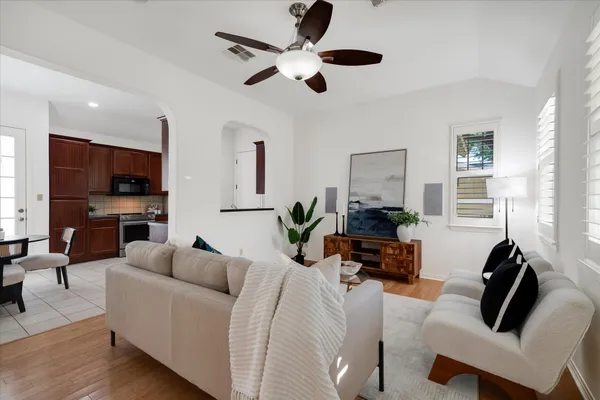 a living room with furniture a fireplace and a flat screen tv