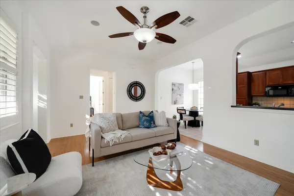 a living room with furniture a rug and a window