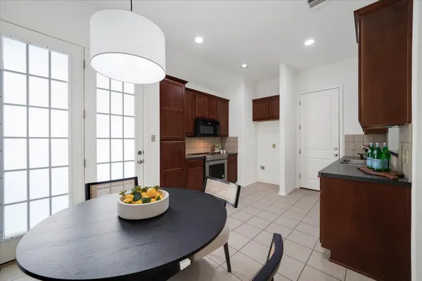 a kitchen with stainless steel appliances granite countertop a sink a stove and a refrigerator