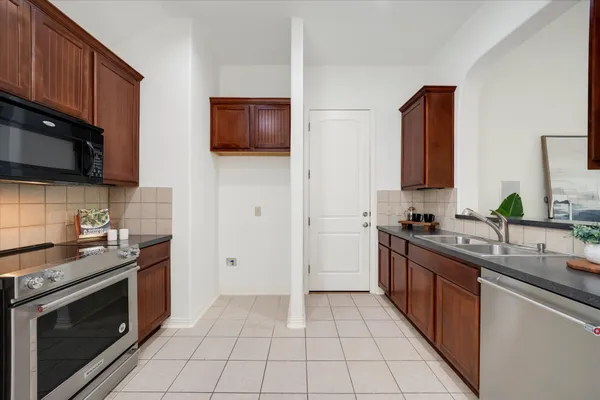 a kitchen with a sink stove and microwave