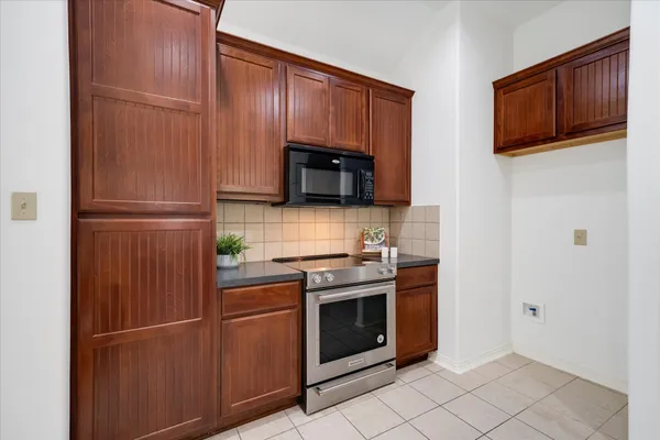 a kitchen with a stove microwave and refrigerator