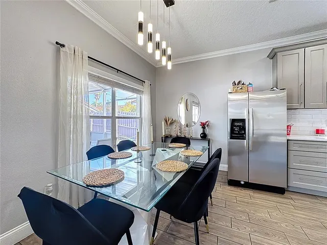 a dining room with furniture a chandelier and window