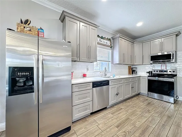 a kitchen with a refrigerator sink and microwave