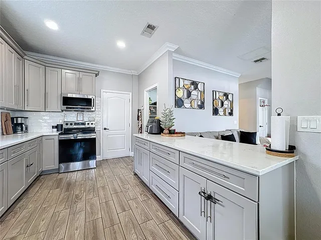 a kitchen with a stove and a refrigerator