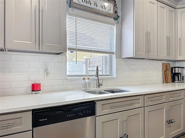 a kitchen with stainless steel appliances white cabinets and a sink