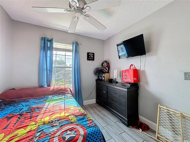 a bedroom with bed and flat screen tv