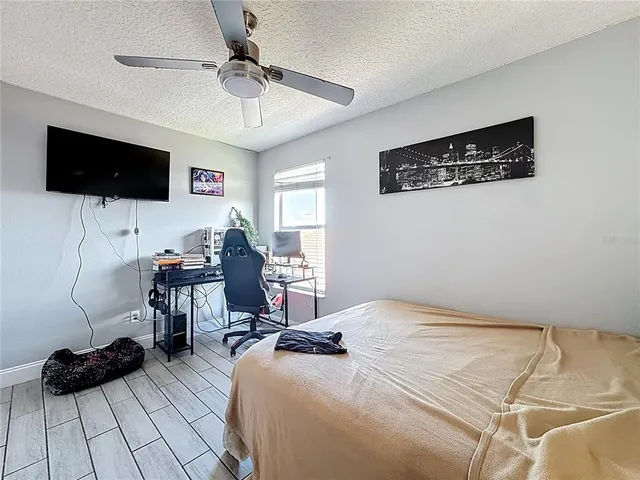 a bedroom with furniture and a flat screen tv