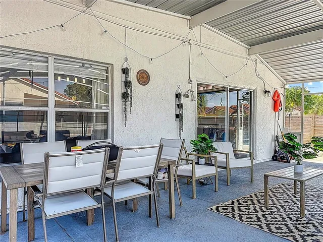 a outdoor space with patio the couches and a dining table with the potted plant