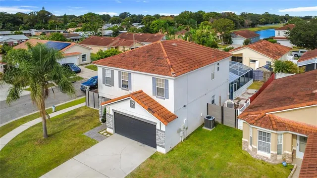 an aerial view of residential house with outdoor space and trees around