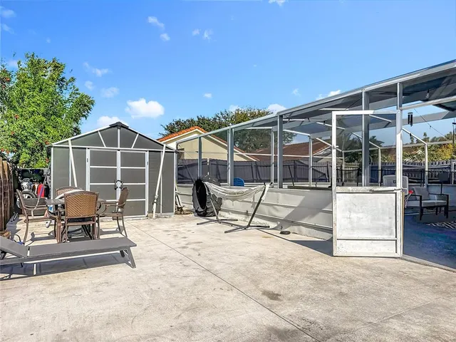 a view of a house with backyard porch and sitting area