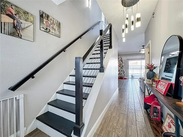 a view of entryway and hall with wooden floor