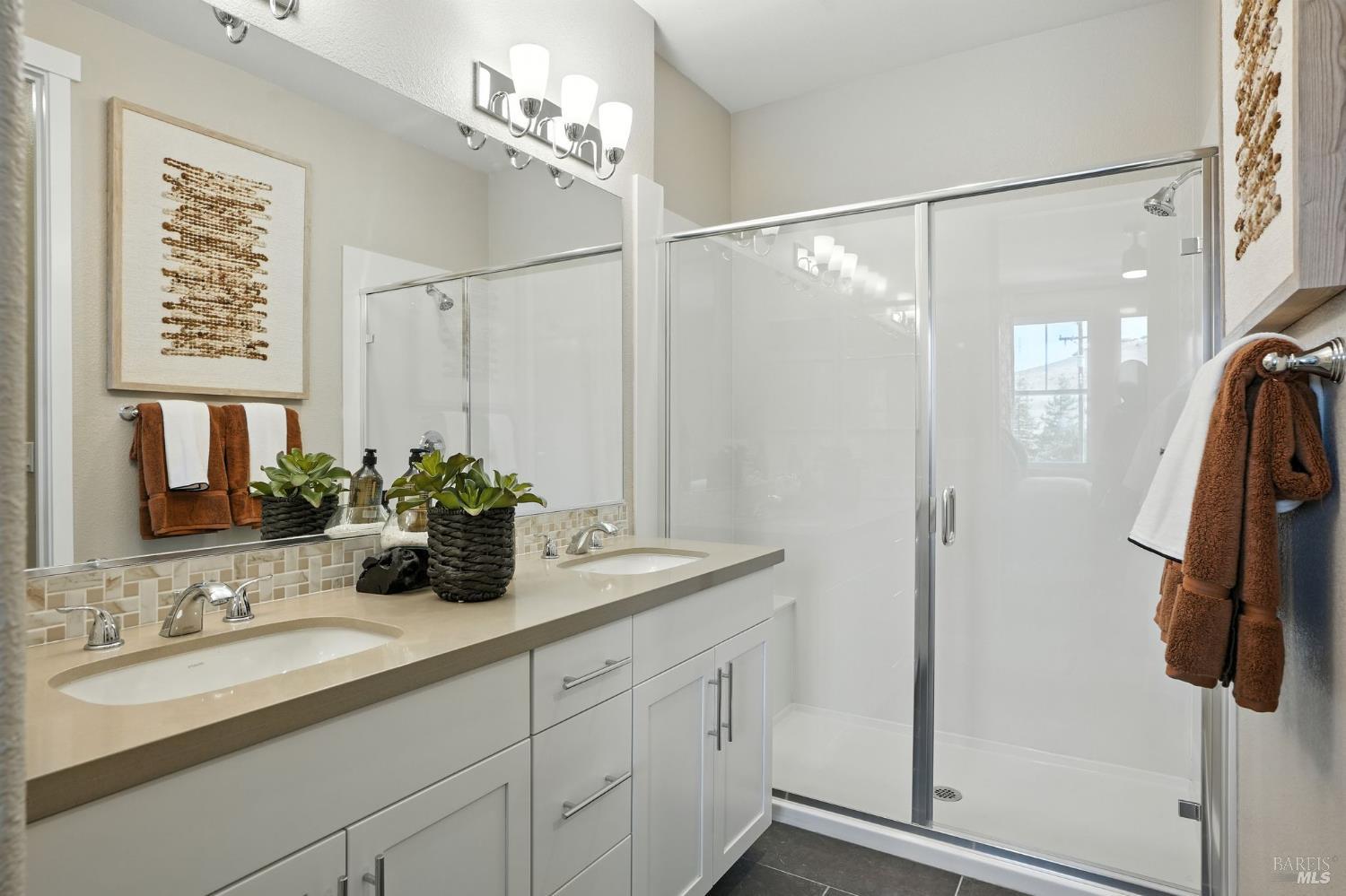 104 Cardamom Lane, Unit 1103 Morgan Hill, CA 95037 - Photo 16 of 19 a bathroom with a double vanity sink a and a shower
