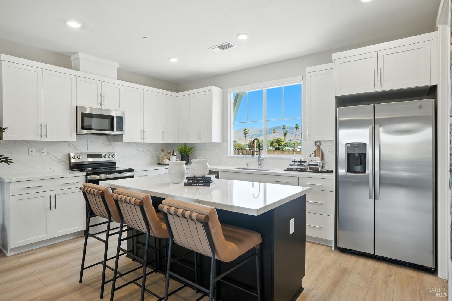 104 Cardamom Lane, Unit 1103 Morgan Hill, CA 95037 - Photo 8 of 19 a kitchen with kitchen island granite countertop a sink stove and refrigerator