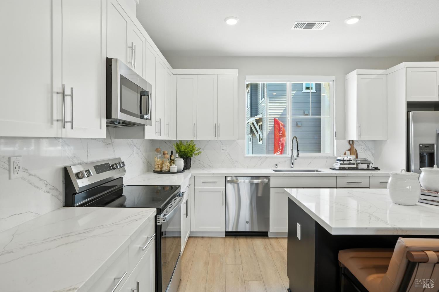 104 Cardamom Lane, Unit 1103 Morgan Hill, CA 95037 - Photo 9 of 19 a kitchen with stainless steel appliances granite countertop a sink stove and refrigerator