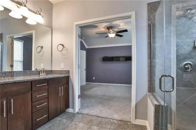 a view of bathroom with a granite countertop sink a mirror and vanity