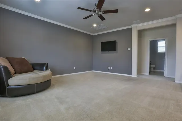 a living room with furniture and a ceiling fan