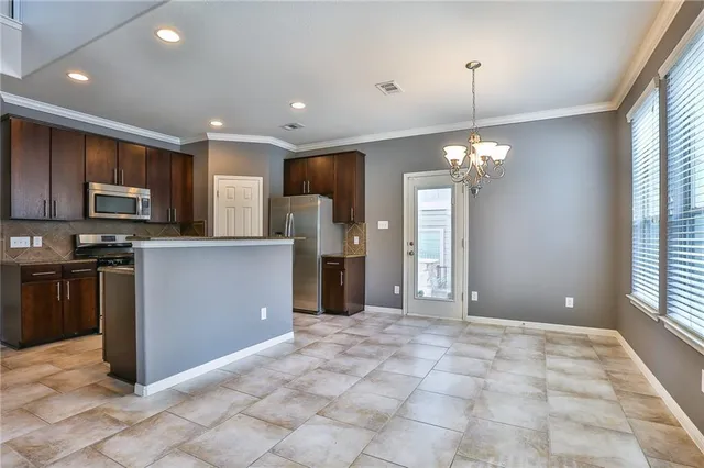 a view of a kitchen with a sink and microwave