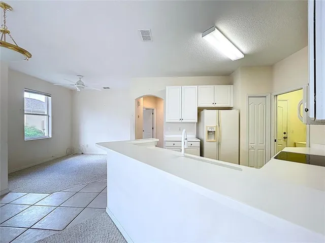 a view of a small space with wooden floor and a ceiling fan