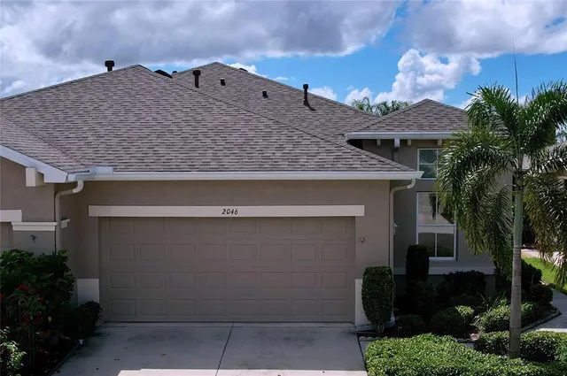 a kitchen with a sink a stove a refrigerator and white cabinets