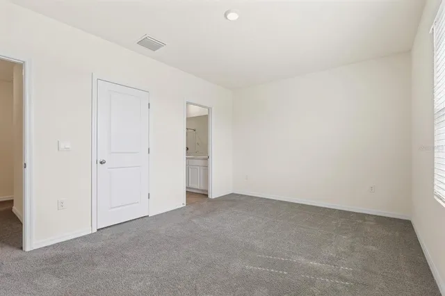 an empty room with an entryway and window