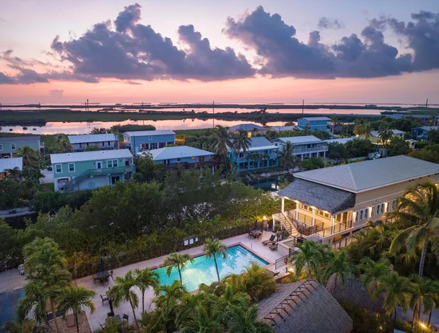 an aerial view of house with yard swimming pool and outdoor seating