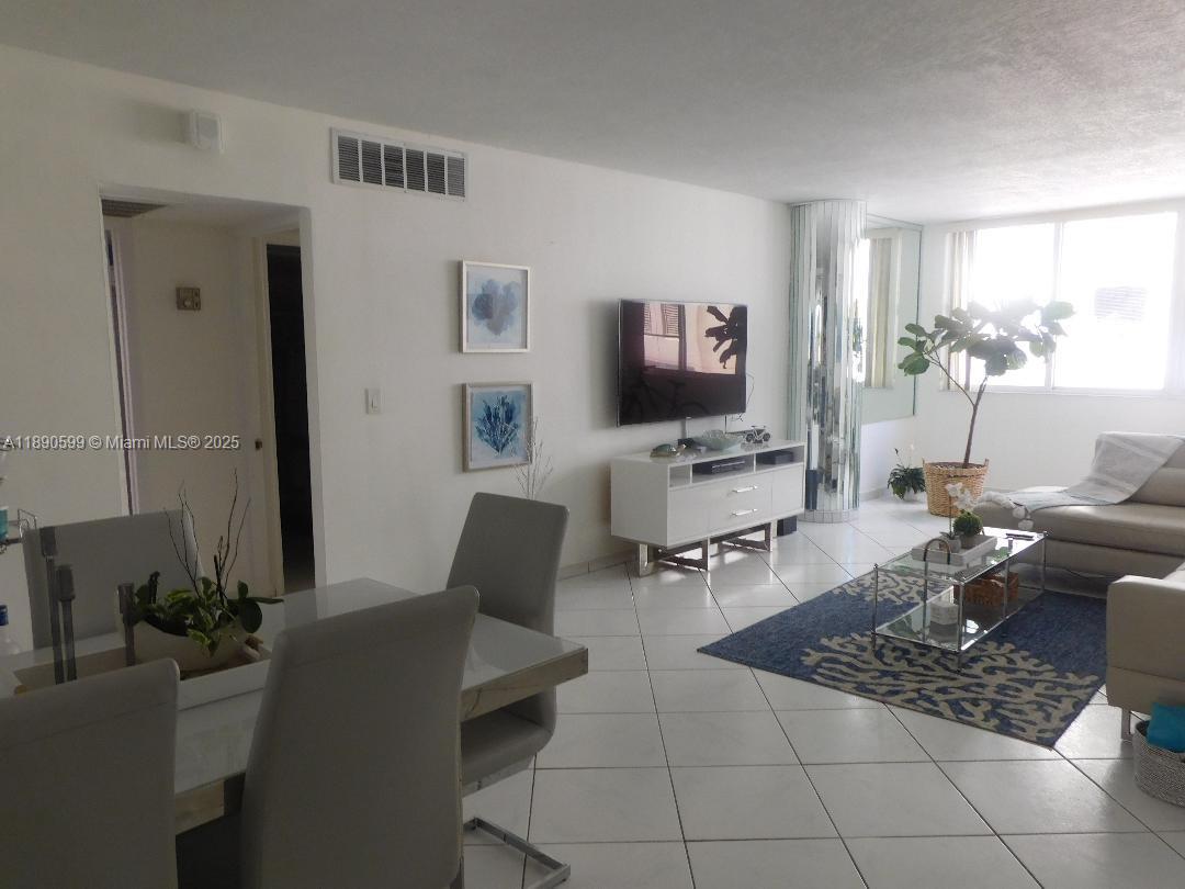 5005 Collins Avenue, Unit 322 Miami Beach, FL 33140 - Photo 4 of 15 a living room with furniture a rug and a window