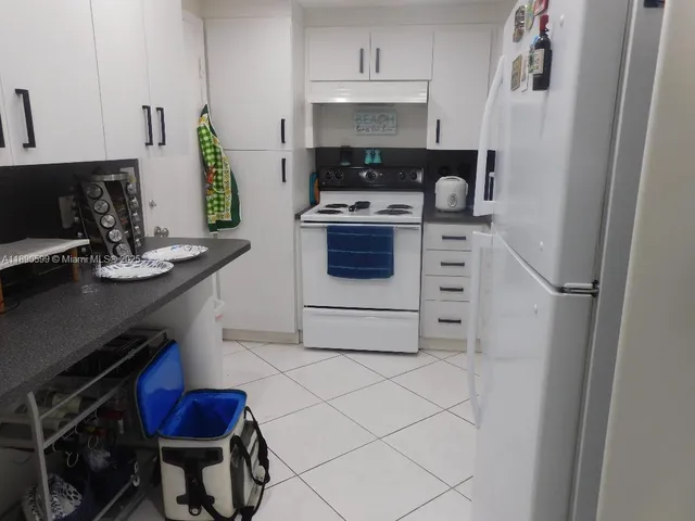 a kitchen with stainless steel appliances a stove a sink and a refrigerator