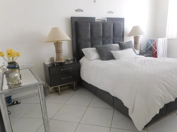 a bedroom with a bed and a lamp