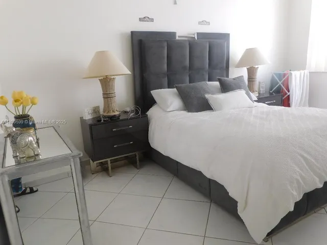 a bedroom with a bed and a lamp