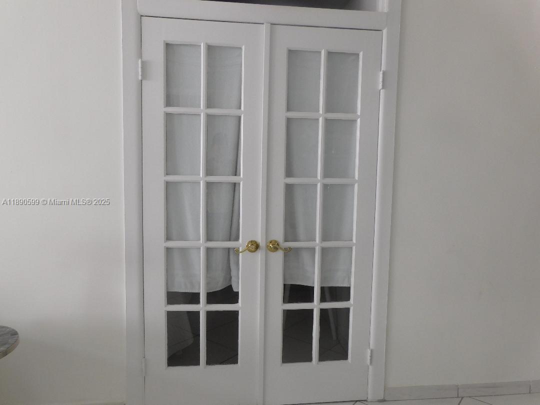 5005 Collins Avenue, Unit 322 Miami Beach, FL 33140 - Photo 10 of 15 a view of an empty room with wooden floor and closet
