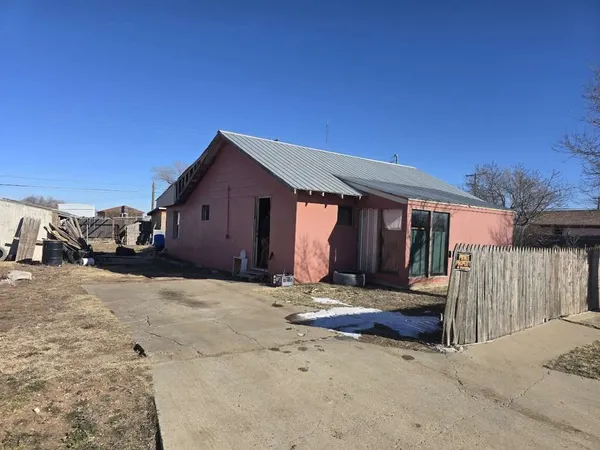 a view of a house with a yard and roof