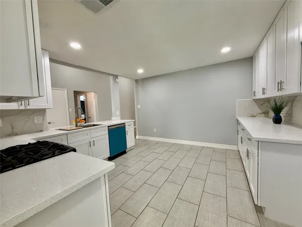 a kitchen that has a sink and a stove in it