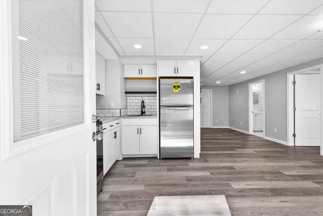 a kitchen with stainless steel appliances kitchen island granite countertop a refrigerator and a stove top oven