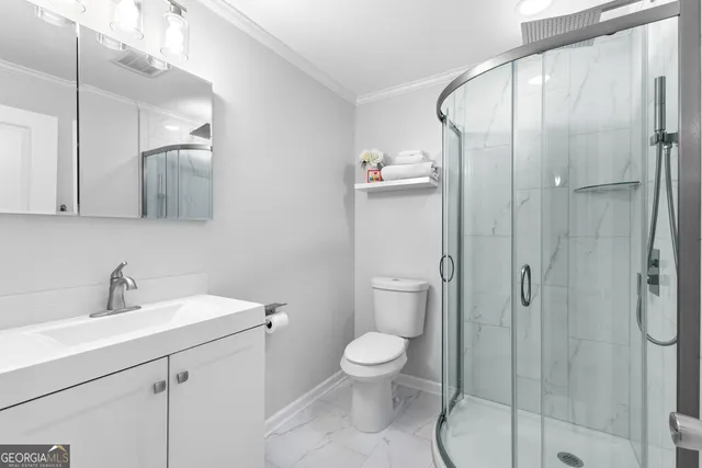 a bathroom with a toilet sink shower and mirror