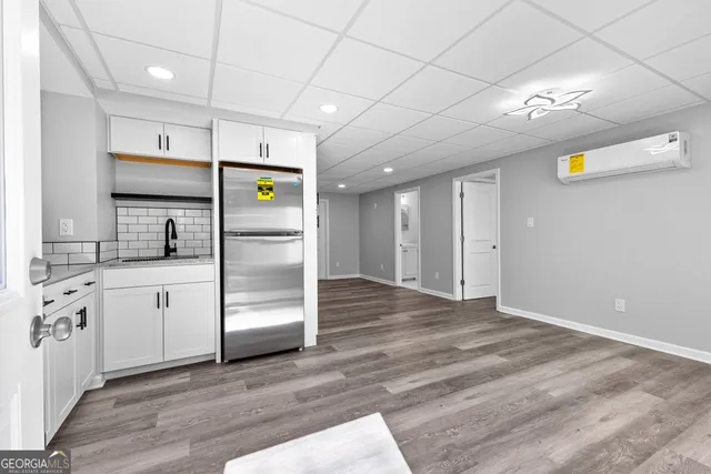 a kitchen with stainless steel appliances a refrigerator and a stove top oven