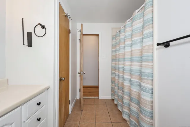 a bathroom with a shower and a sink