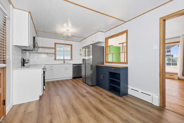 a view of a kitchen with a sink dishwasher and a fireplace