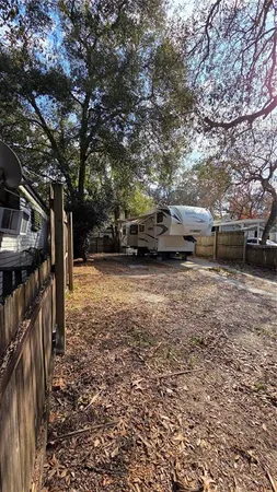 a view of a yard with car parked