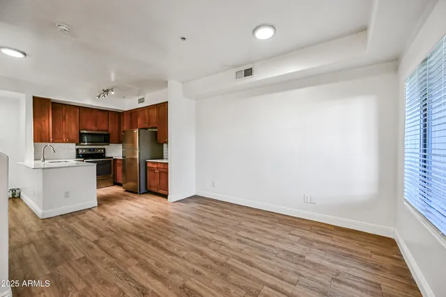 a view of kitchen with wooden floor and electronic appliances