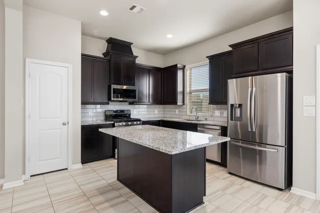 a view of workspace with furniture and large window