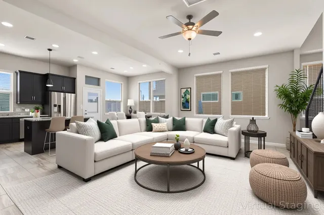 a living room with furniture potted plant and a large window