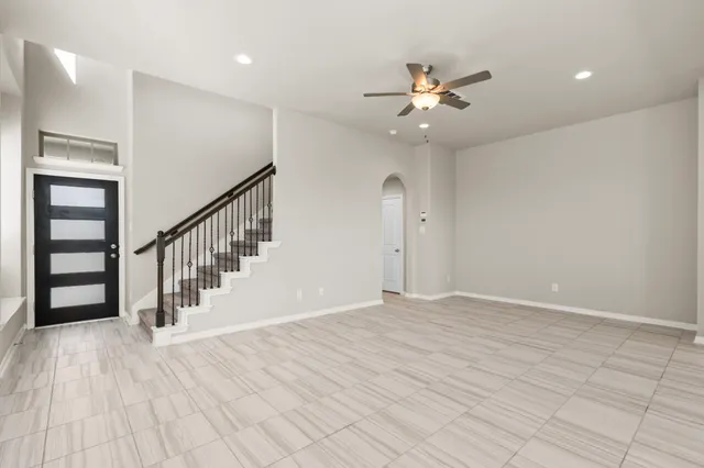 a living room with furniture kitchen view and a large window