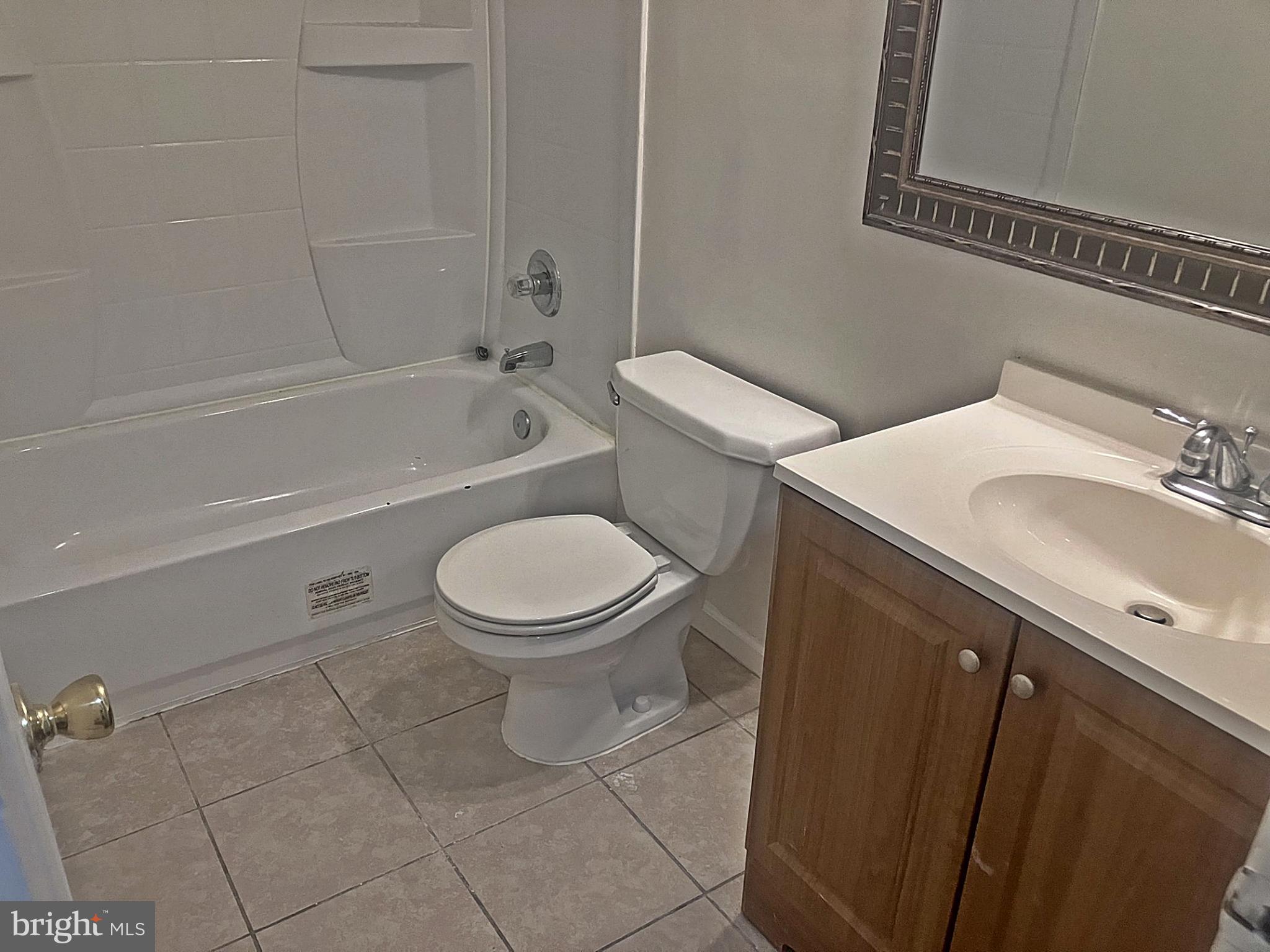 14909 Cleese Court, Unit 4CA Silver Spring, MD 20906 - Photo 25 of 43 a white toilet sitting next to a bath tub